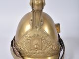 brass plated bell on a white surface with a white background
