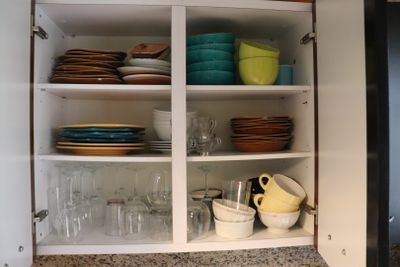 a cabinet with dishes and glasses in it