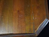 a close up of a wooden table with a clock on it