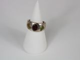 a close up of a ring on a white cone on a white surface