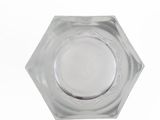 a clear glass bowl with a silver lid on a white surface