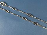 a close up of a pair of silver chain bracelets on a blue background