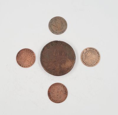 a group of five different coins sitting on top of a white surface