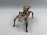 an old wooden chair with a metal handle on a white surface