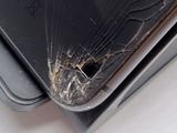 a broken cell phone sitting on top of a laptop