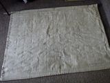 a large piece of cloth on the floor next to a chair