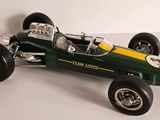 an image of a green and yellow race car on a white surface