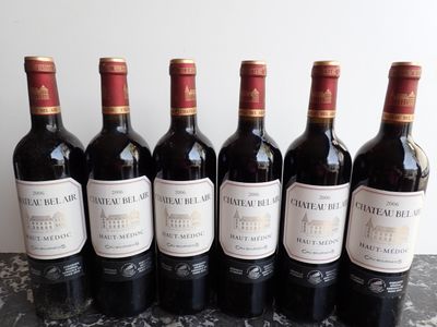 six bottles of wine are lined up on a table