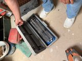 a man that is holding a tool in a tool case