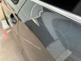 a car with a broken window and a broken door handle