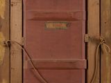 painting of a red door with a rope hanging from it ' s side