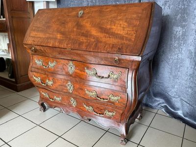 a small wooden desk with many drawers on it