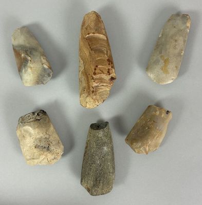 five different types of stone tools are arranged in a circle