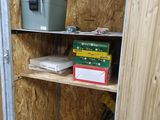a small room with shelves and a cooler in it