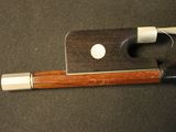 a violin bow and a bow rest on a table
