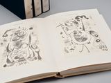 a book with two drawings on it and a book with a picture on it