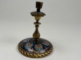 an image of a blue and gold candle holder on a white surface