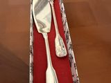 a silverware set in a box on a wooden table