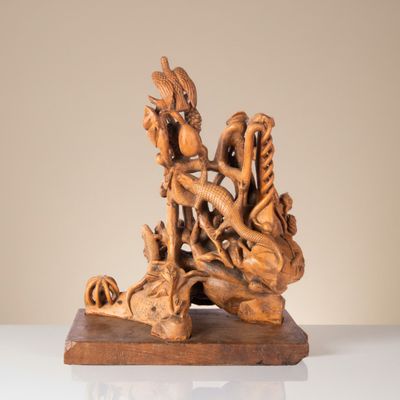 a wooden sculpture of a dragon on a table