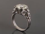 an engagement ring with a large oval diamond surrounded by smaller diamonds