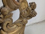 a gold mirror with a bird on top of it