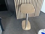 a small table with a stool on it in a room