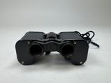 an image of a pair of binoculars sitting on top of a table
