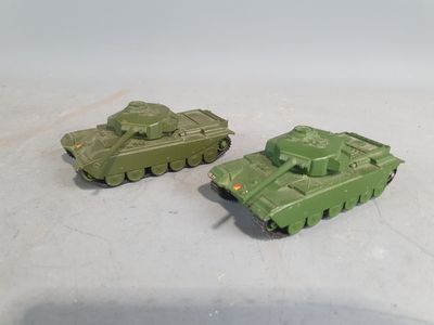 two toy tanks sitting next to each other on a table
