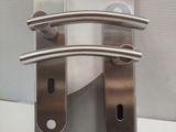 two stainless steel door handles that are attached to each other