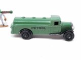 a green toy truck with a man holding a baseball bat