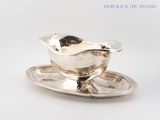 a silver plate with a saucer and a spoon on it