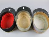 four hats are lined up in a row on a white surface