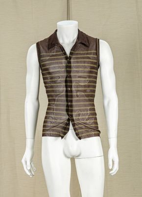 a mannequin dressed in a brown vest and tie
