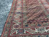 a red and blue rug laying on the ground