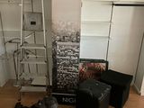 a room with a ladder, a chair, a bookcase, and a vacuum on the floor