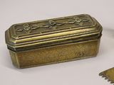 a small brass box and a small metal box