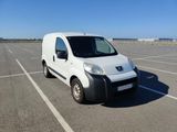 a small white van parked in a parking lot
