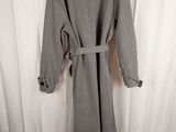 grey wool coat with belt on hanger on a white background