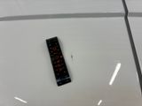 a remote control sitting on the floor in the bathroom