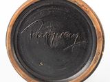 a close up of a black plate with a writing on it