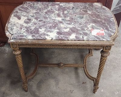 a marble topped table with a drawer in the background