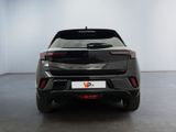 the rear end of a black car in a white room