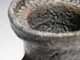 a vase that is sitting on a table with a white background
