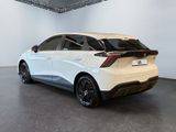 the rear end of a white car in a white room