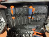 someone is holding a tool kit in a case with tools inside of it