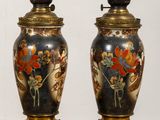 pair of vases with flowers and birds painted on them sitting on a table