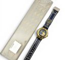 a watch that is sitting next to a box