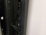 a close up of a wall mounted device with wires