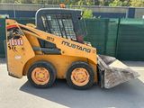 a picture of a yellow ski - loader parked in a parking lot