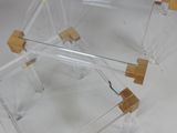 a clear glass table with a wooden base and a clear glass table top
